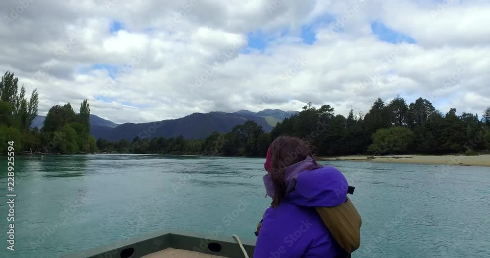 boat with jet engine, navigating the Puelo and Manso rivers at high speed, a young woman sightseeing sitting in front boat with jet engine, navigating the Puelo and Manso rivers at high speed, a young woman sightseeing sitting in front