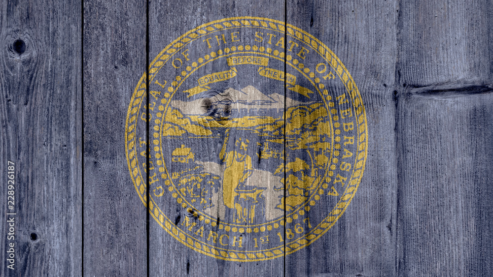 USA Politics News Concept: US State Nebraska Flag Wooden Fence