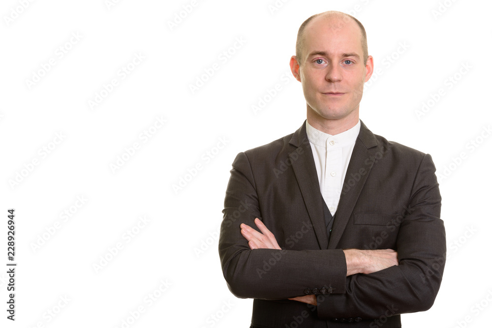 Bald Caucasian businessman with arms crossed looking at camera Bald Caucasian businessman with arms crossed looking at camera