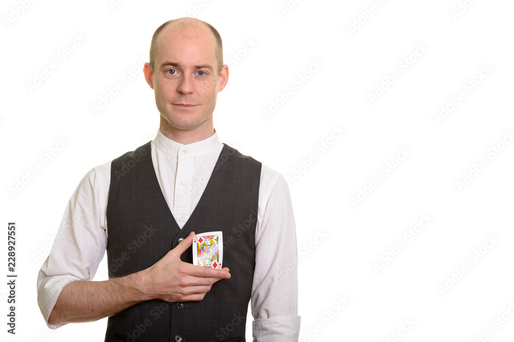 Bald Caucasian magician man bending Jack of Diamonds card Bald Caucasian magician man bending Jack of Diamonds card