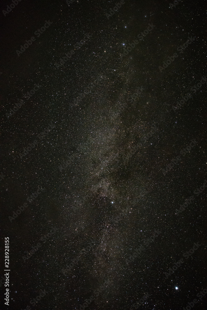 Bright milky way on a summer night through the clouds