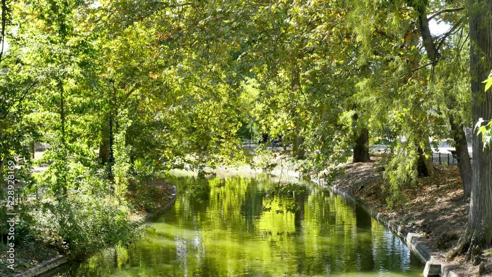 View of the public garden (Jardin publique in french) of Bordeaux, a city located in southwest france. There is a lot of greenery there and a little river. View of the public garden (Jardin publique in french) of Bordeaux, a city located in southwest france. There is a lot of greenery there and a little river.