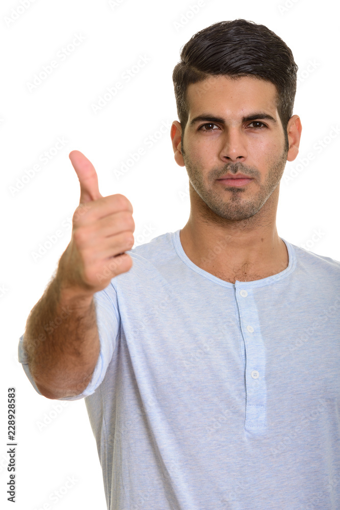 Young handsome Persian man giving thumb up