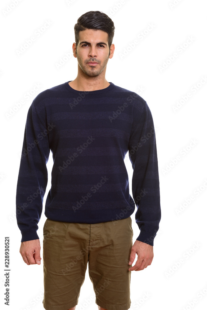 Studio portrait of young handsome Persian man standing Studio portrait of young handsome Persian man standing