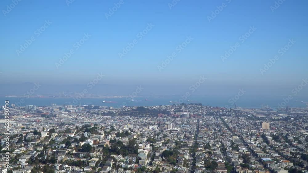 Potrero Hill, The Castro and The Mission Districts in San Francisco viewed from Twin Peaks on a hazy fall day. Blue sky above low level air pollution. Potrero Hill, The Castro and The Mission Districts in San Francisco viewed from Twin Peaks on a hazy fall day. Blue sky above low level air pollution.