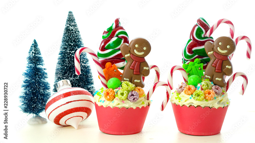 On-trend candyland festive Christmas cupcakes on white background.