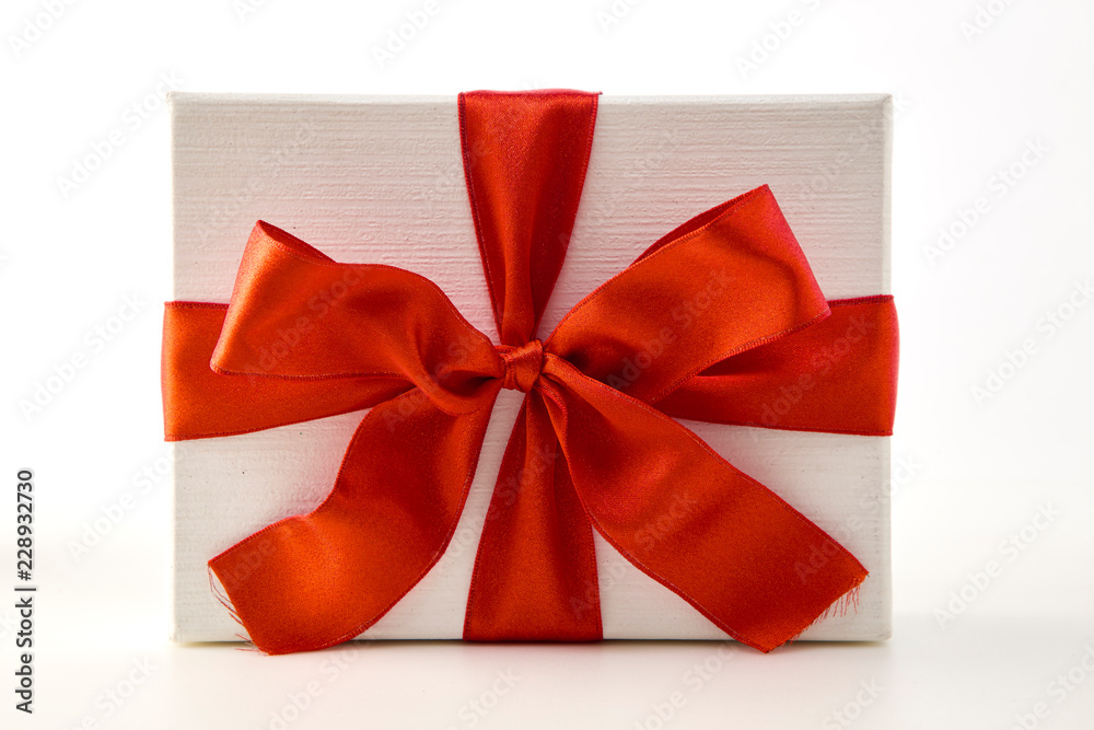 White gift box with red ribbon bow