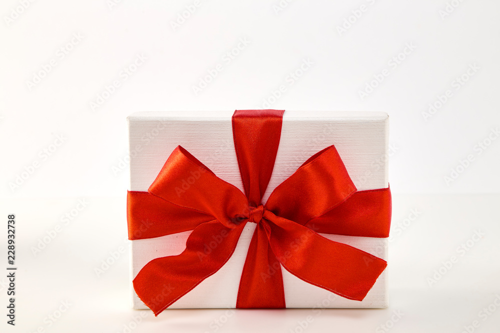 White gift box with red ribbon bow White gift box with red ribbon bow
