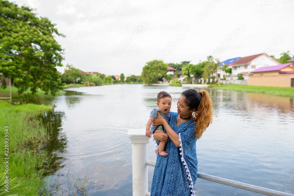 Mother and baby son bonding together at the park Mother and baby son bonding together at the park