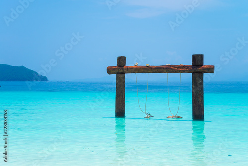 Swing on beautiful tropical island white sand beach blue sky sunny day - Summer breeze holiday