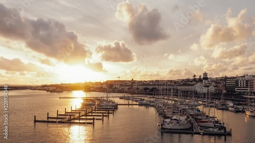 Panoramic view of harbour with yachts and boats in Ponta Delgada, Sao Miguel, Azores at beautiful sunset, Time lapse
