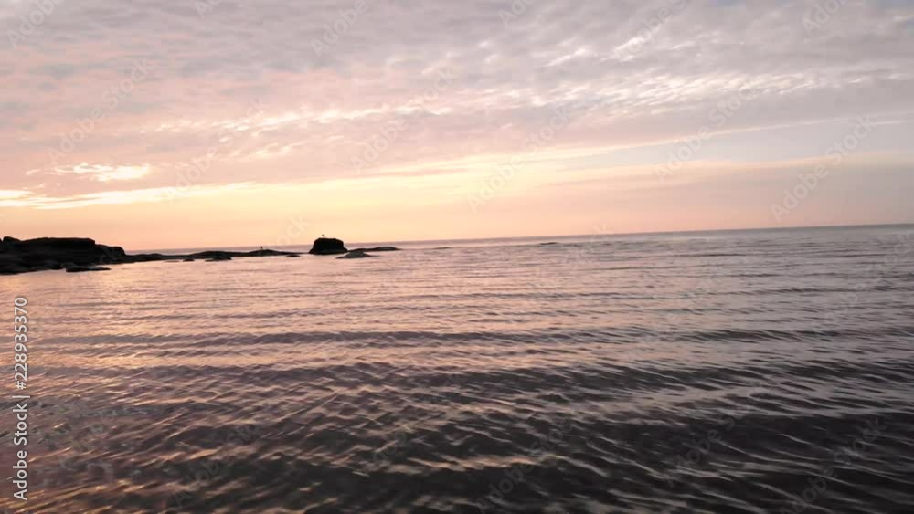 Aerial Shot Over The Calm Ocean Cape With A Beautiful Sunset Aerial Shot Over The Calm Ocean Cape With A Beautiful Sunset