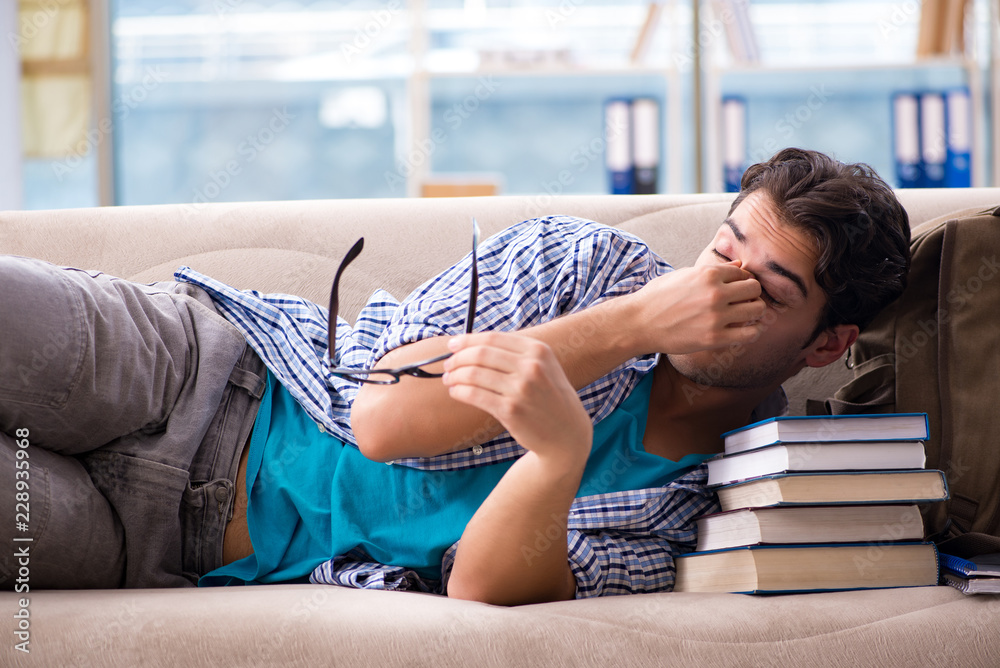 © Elnur - Tired student lying on the sofa