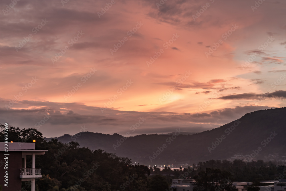 A dramatic sunrise over the city of Patong from the southern hillside.