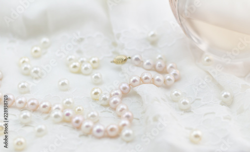 Pearls, lace and perfume soft focus photo white and pink background