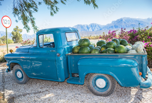 Old truck parked next to highway route 62 in Western Cape South Africa with vegetables and fruit - watermelons and pumpkins