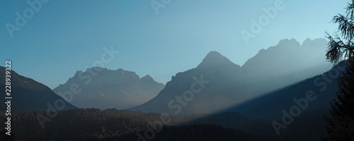 Fototapeta Naklejka Na Ścianę i Meble -  Austria, Tyrolean Alps. Road to Fern pass. Wonderful landscape at the mountain and wood during sunrise. The Zugspitze peak on the back