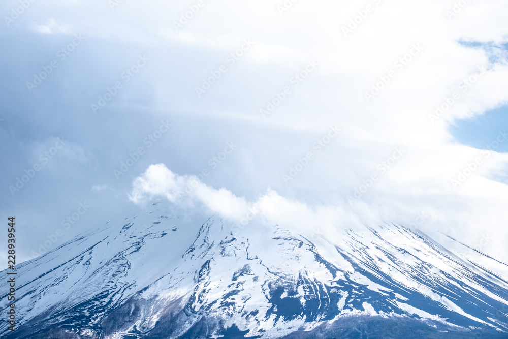 Close up top of beautiful Fuji mountain (fujisan) with snow cover on the top with could, Japan