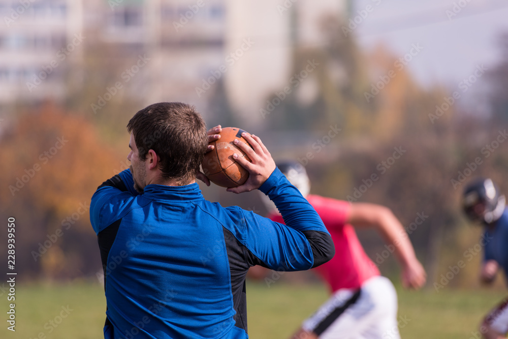 Fototapeta premium american football team with coach in action