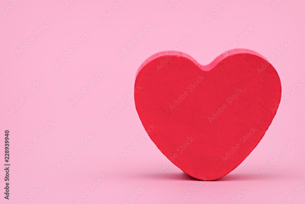 Red heart on a pink background, front view