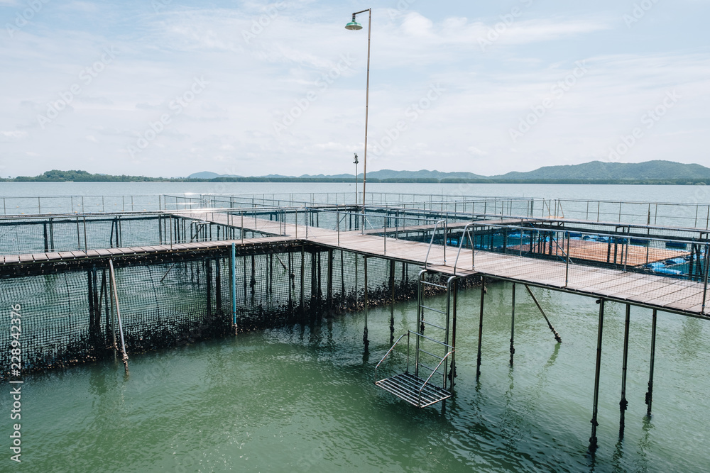 Wooden pedestrian path over sea surface with beautiful view of Ao Khung Kraben bay at Sea Fish Farming Demonstration Unit, Royal Project, Ta Mai District, Chanthaburi.