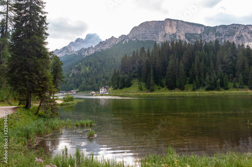 Mountain slopes along the shoreline of Lake Misurina, in the Italian Dolomites, on a Summer's Afternoon.