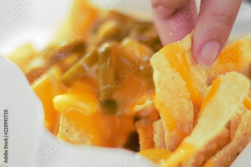 closeup of nachos with cheese and jalapeno