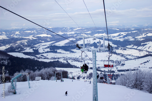 Cable car with skiers in the mountains, winter holidays, Ukrainian Carpathians, background,