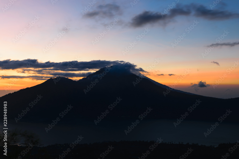 Sunrise view from Gunung Batur volcano in Bali with visible Mount Agung volcano
