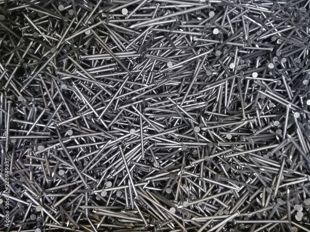 background of building materials, set of identical nails for repair, working tools - Bolts, hooks.