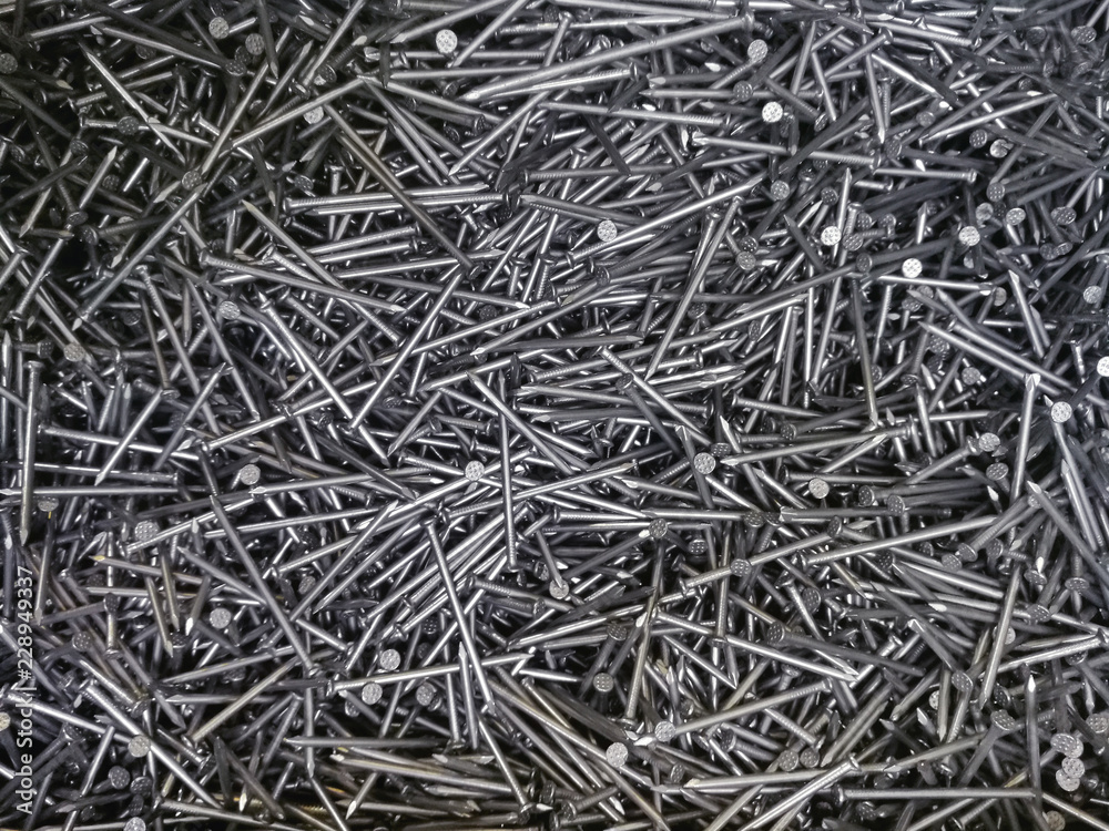 background of building materials, set of identical nails for repair, working tools - Bolts, hooks. background of building materials, set of identical nails for repair, working tools - Bolts, hooks.