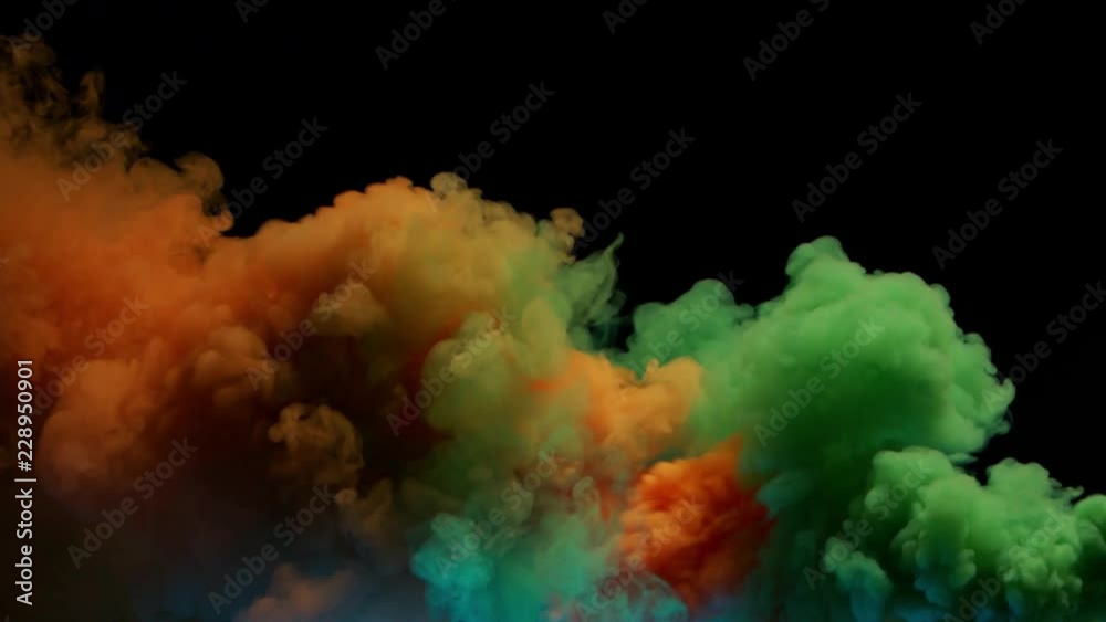 orange and green bomb smoke on black background orange and green bomb smoke on black background