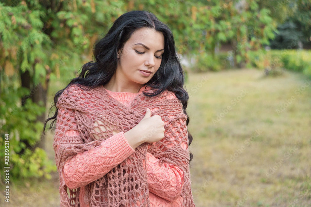 Brunette girl wraps herself in an shawl