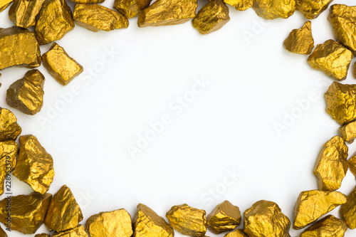 A pile of gold nuggets or gold ore on white background, precious stone or lump of golden stone, financial and business concept.