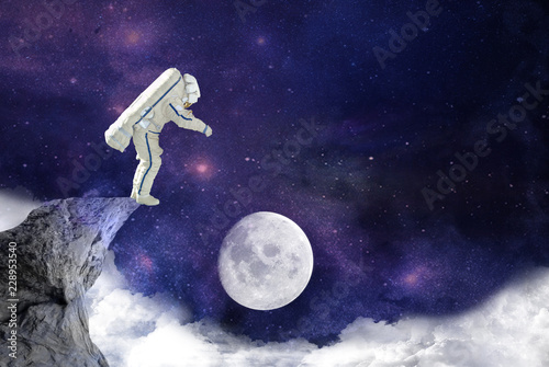 spaceman jumping from rock to moon,mission.elements of this image furnished by NASA © red150770