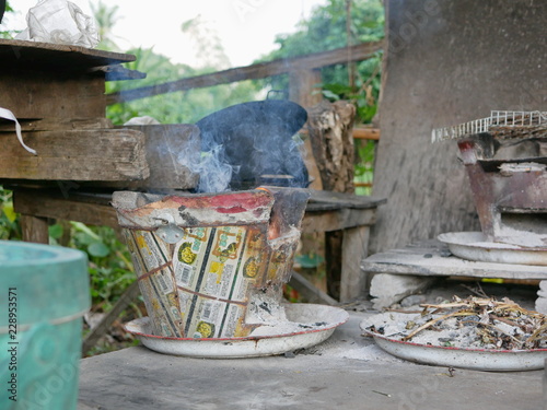 Thai traditional charcoal stove with smoke as the fire has been started and getting ready for cooking photo