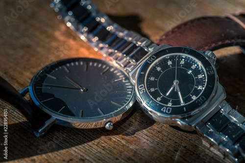 Two classic wrist watches on wood