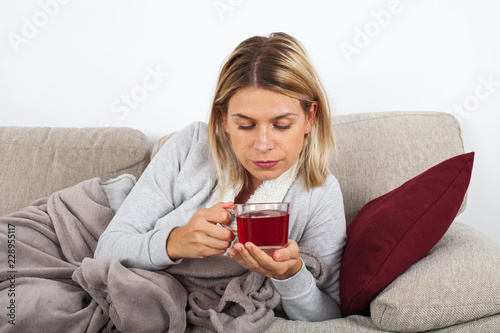 Woman drinking tea on the sofa