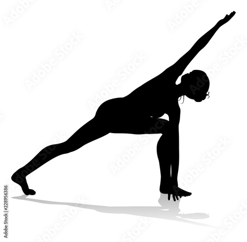 A silhouette of a woman in a yoga or pilates pose 