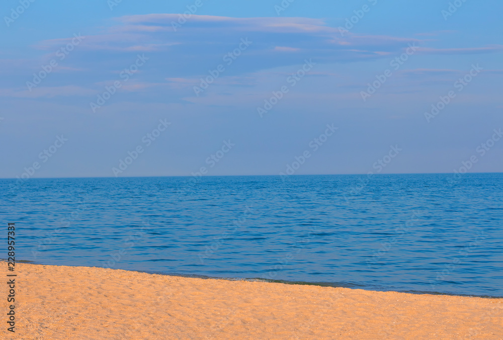 sandy beach and calm sea water 