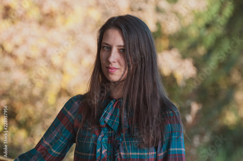 Portrait of Young Fashion Woman Outdoor on Autumn Background