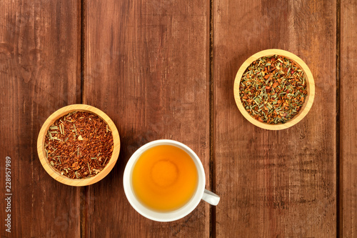 An overhead photo of tea on a dark rustic wooden background with copyspace