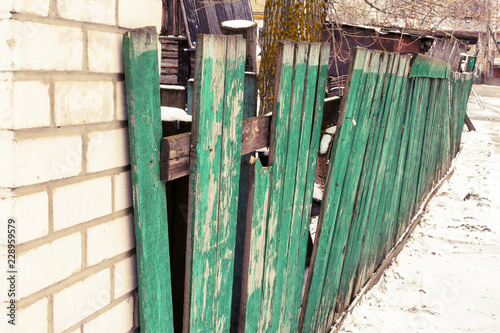 Old green wooden broken fence