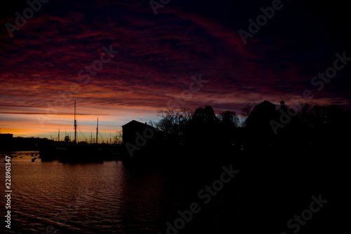 Boats and colorful clouds in the morning at the harbour of Stockholm