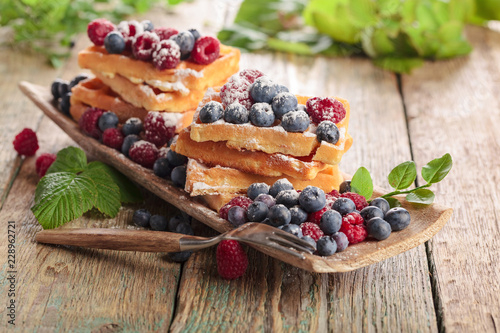  Yummy sweet waffles with raspberries and blueberries.