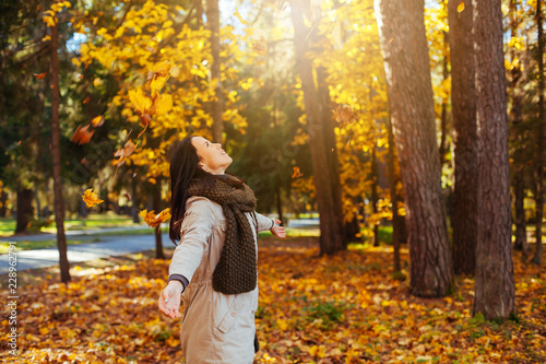 Beautiful elegant woman in autumn park. Fall yellow garden background