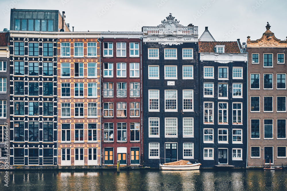 Obraz premium houses and boat on Amsterdam canal Damrak with reflection. Ams