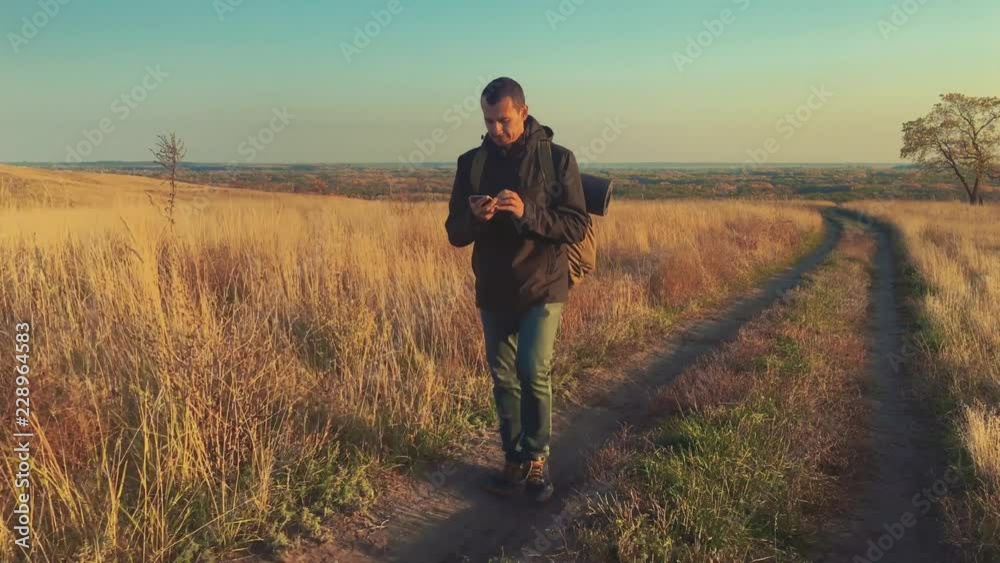 Hiker man tourist walking mountains trekking alone. Active successful man travelling with backpack. Travel Concept. Active traveler go travel in mountains outdoors lifestyle. Hiker man tourist walking mountains trekking alone. Active successful man travelling with backpack. Travel Concept. Active traveler go travel in mountains outdoors lifestyle.