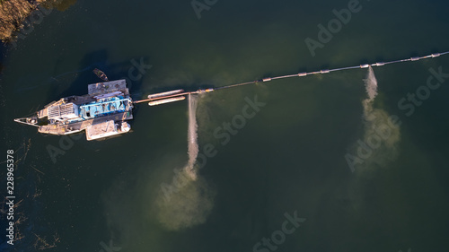 Foto On the river there are works on extraction of sand. Works dredge