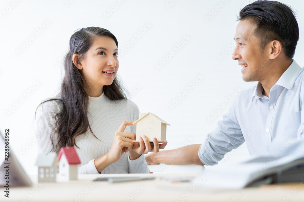 Happy couple plan buying house.Concept for Couple saving money for buy home and real estate. Select material for decorate furniture. Happy couple plan buying house.Concept for Couple saving money for buy home and real estate. Select material for decorate furniture.